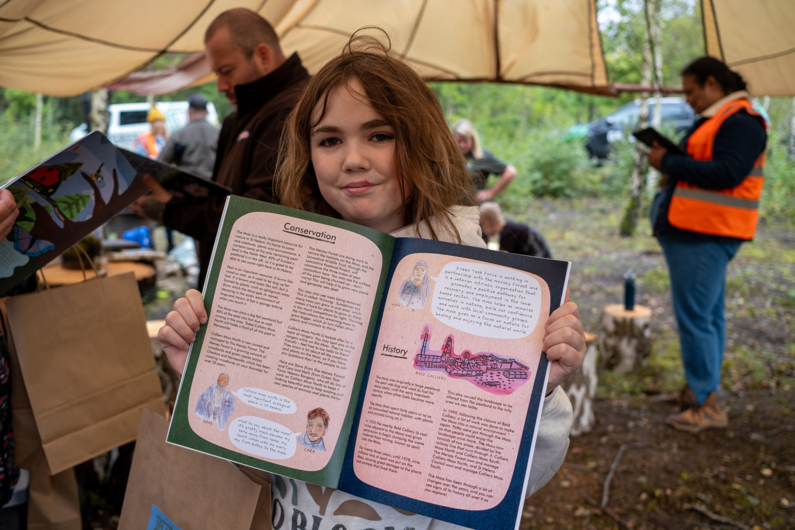 Photograph of a child holding up an activity book