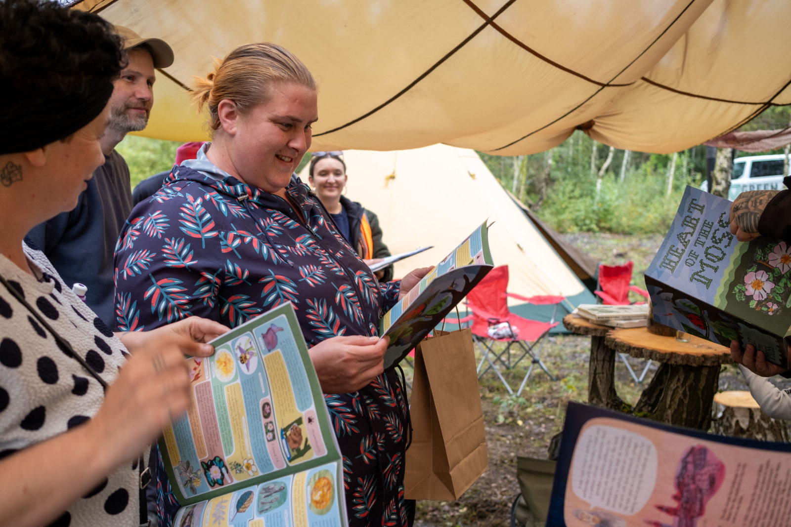 Photograph of a group of people looking at activity books