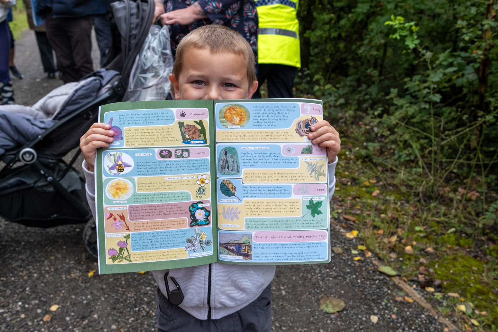 Photograph of a child holding open a colourful activity book