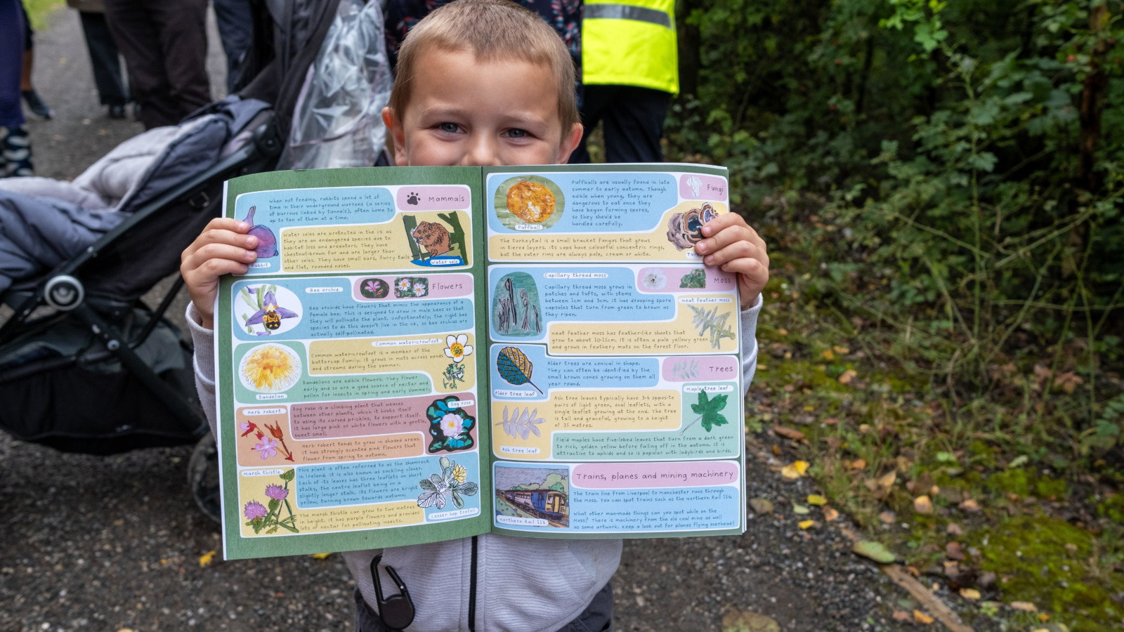 Photograph of a child holding open a colourful activity book