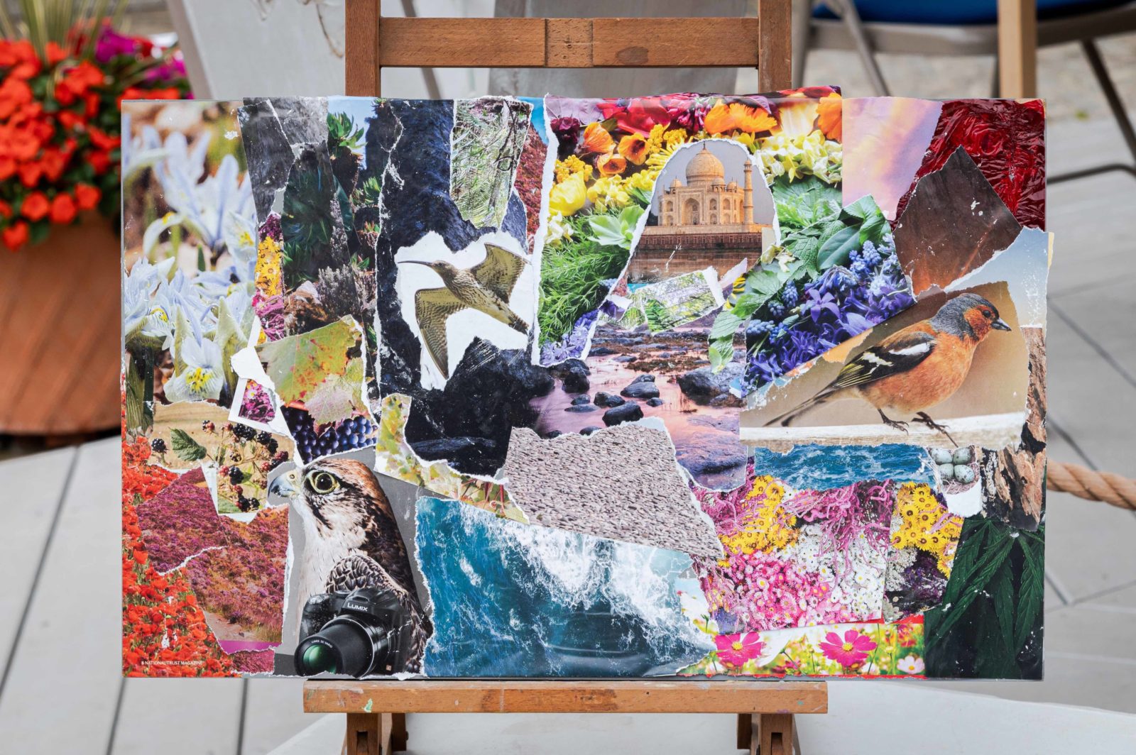 A collage on a wooden board is photographed leaning on an easel.