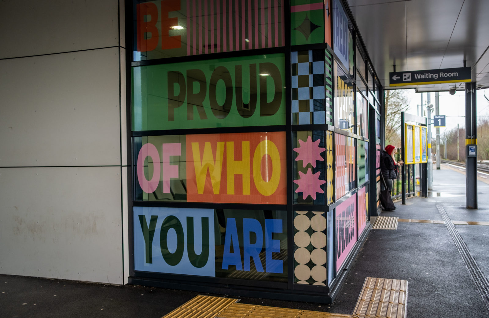 Close up of one side of the window reading ‘Be proud of who you are’.