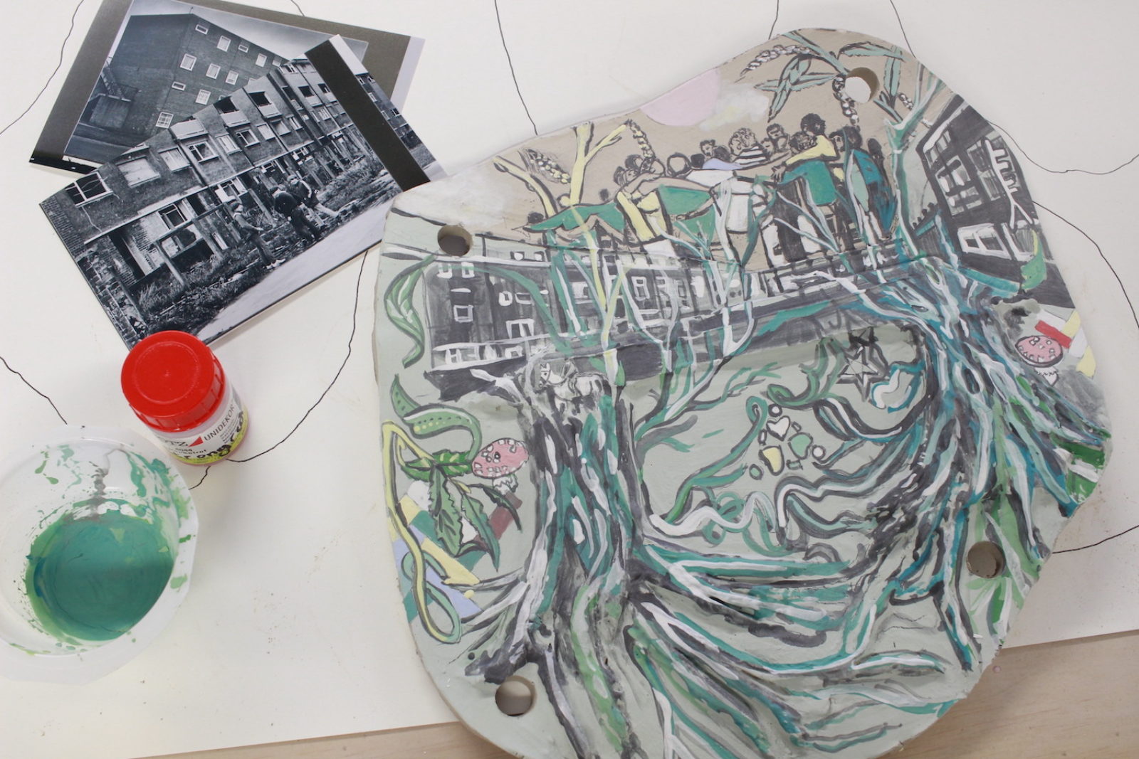 A photograph of one of Fran's artworks for the trail after having colour added to it. Next to it are some photographs of buildings.