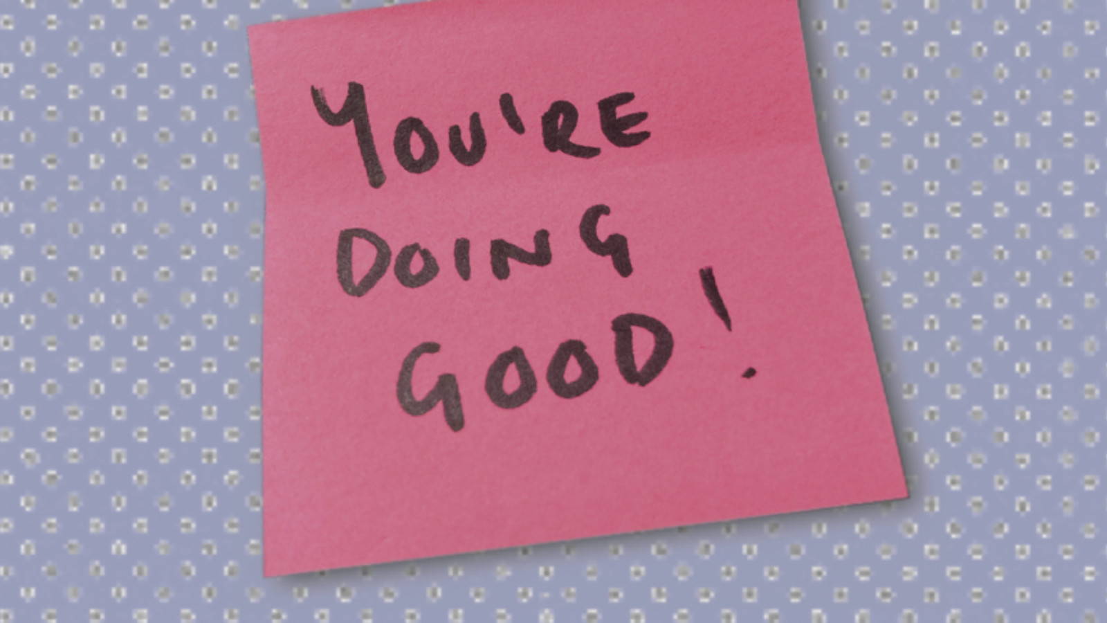 A pink sticky note with the words 'You're doing good!' written in black marker.