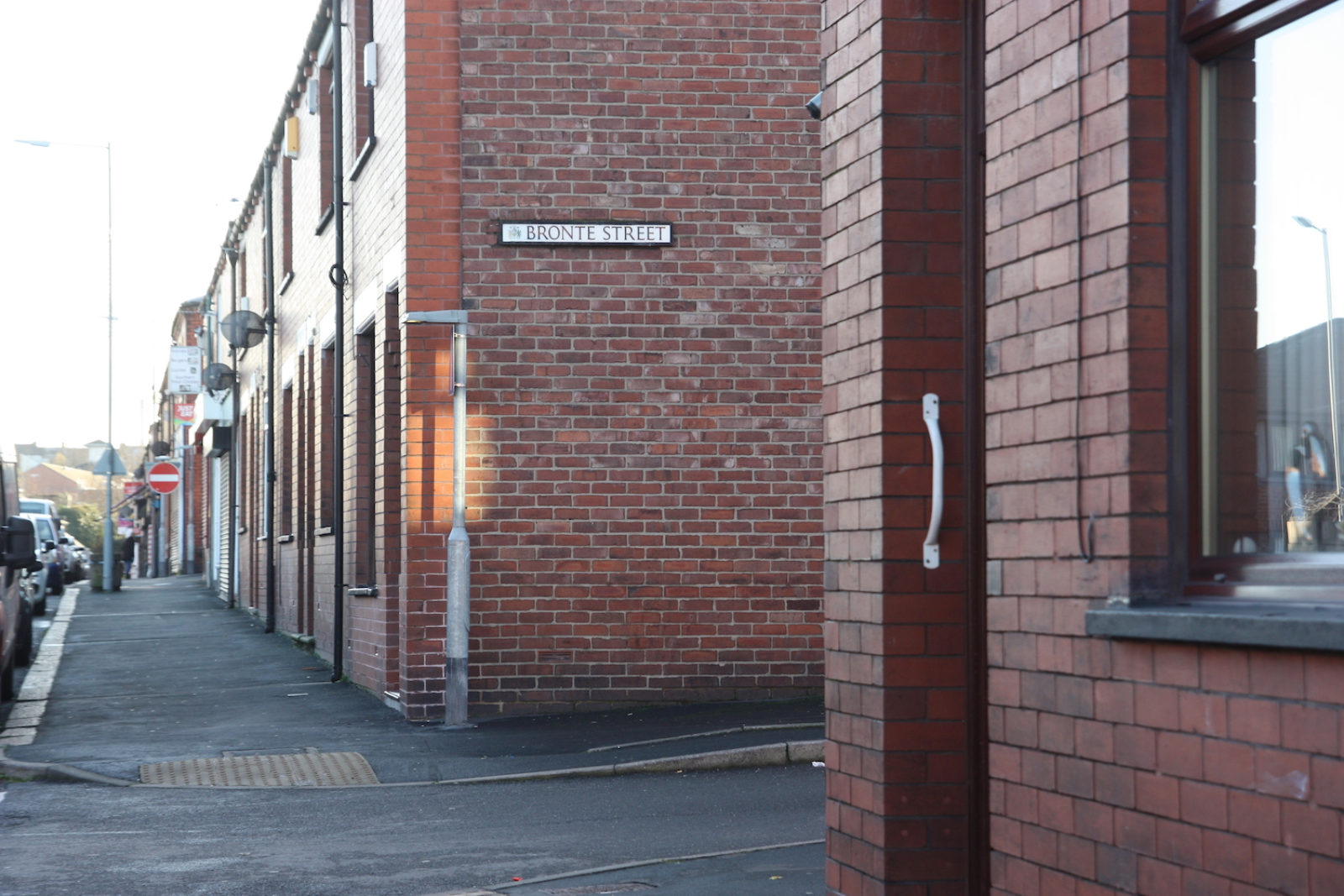 Bronte Street sign is on the side of a red brick house.