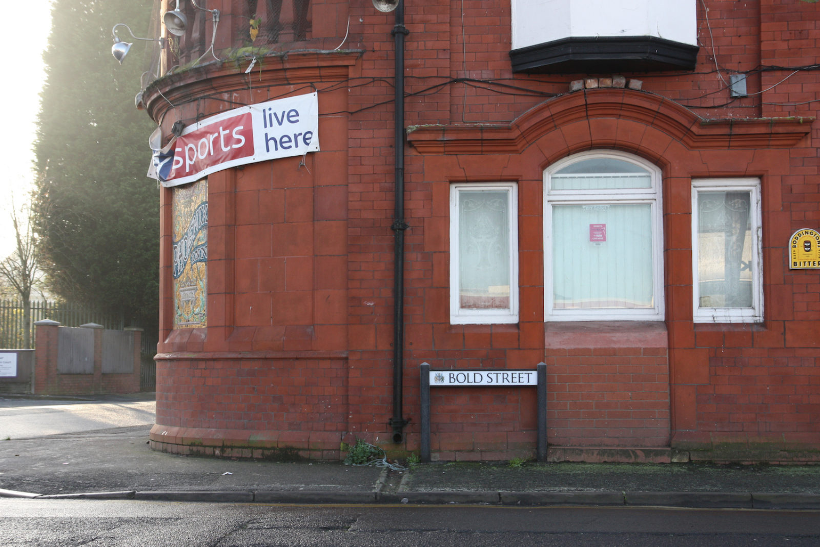 Bold Street sign is in front of a red brick pub with a rounded wall and sky sports banner.
