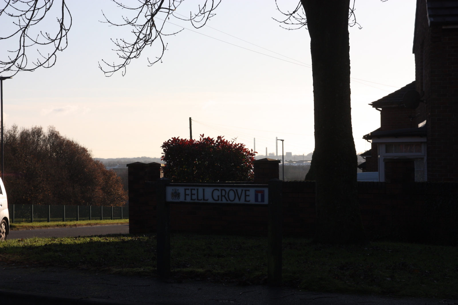 Fell Grove sign is photographed with the sun setting behind it