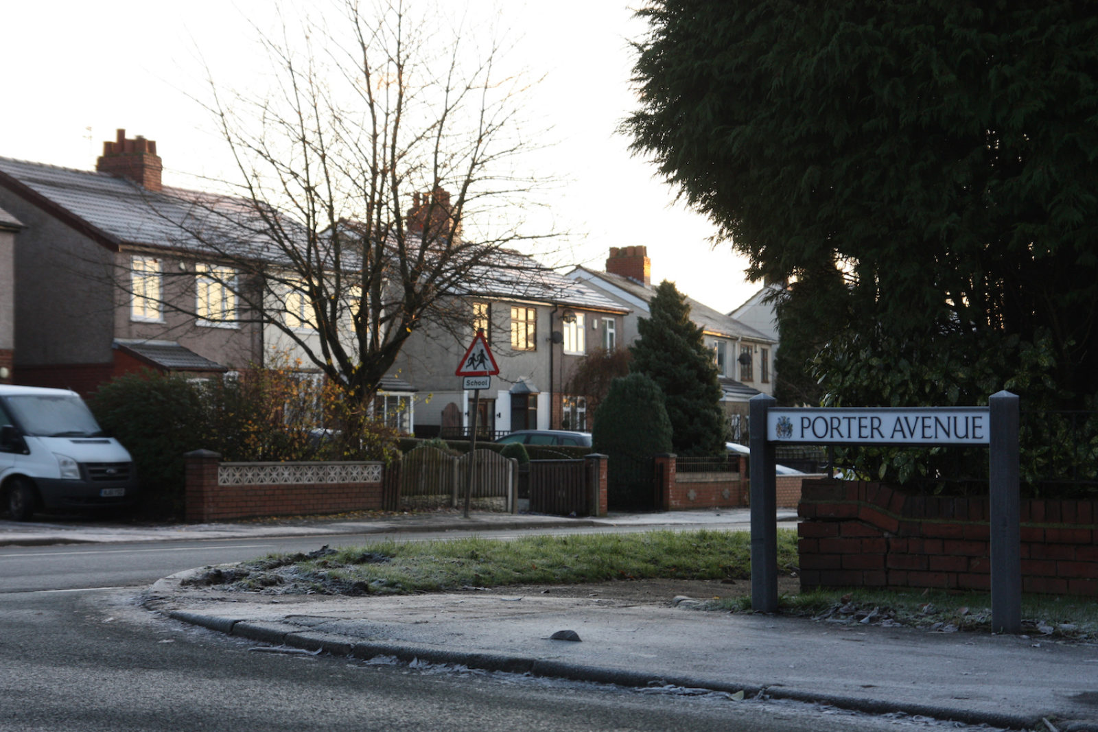 Porter avenue sign is on the end of a road in front of semi detached houses.