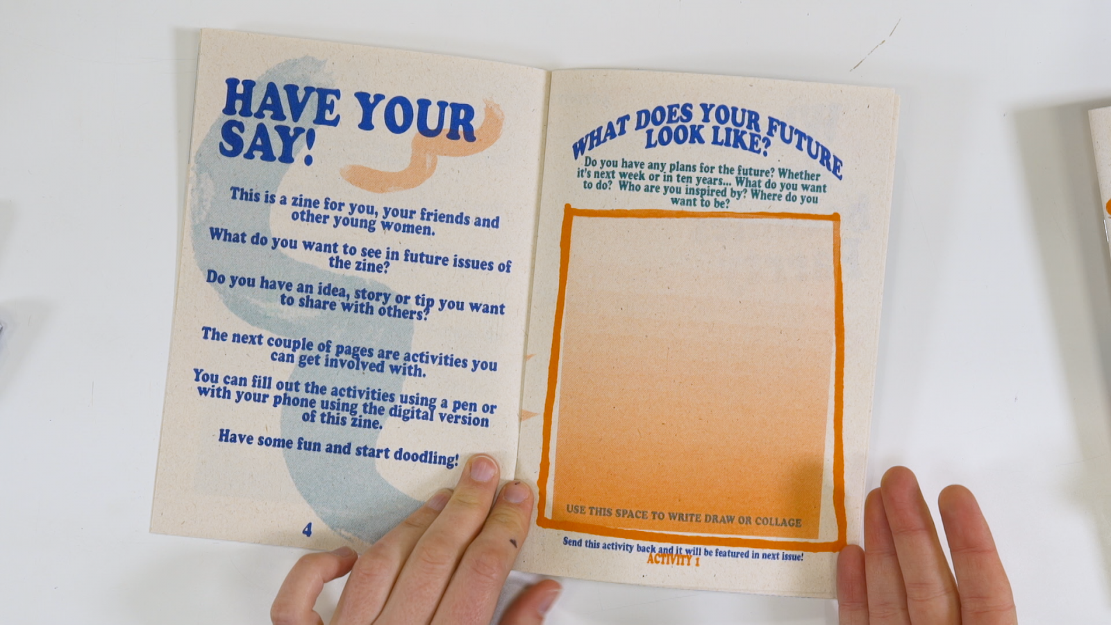 Two hands holding open the Parrty Zine. On the left hand page are the words 'Have your Say!' with a short text underneath expanding on the imperative. The right hand page asks the question 'What does your future look like?' and offers a space where you can draw or write your vision.