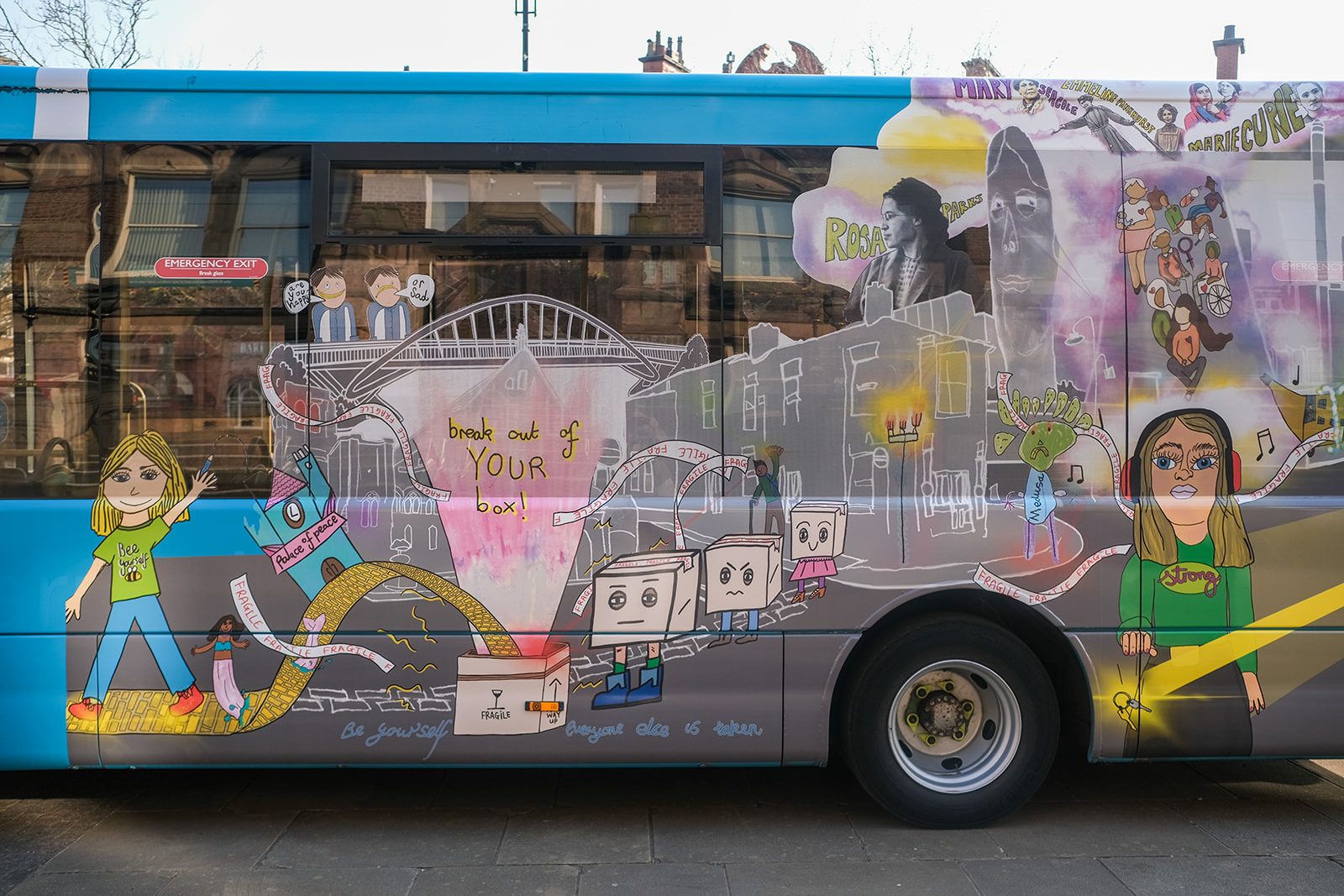 An Arriva North West bus is decorated with colourful designs and illustrations of people and landscapes with inspiration words dotted within the designs.