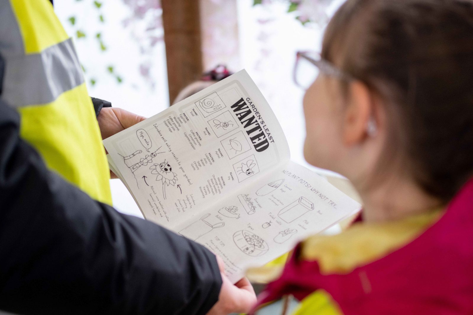 Schoolchildren reading a zine about gardening