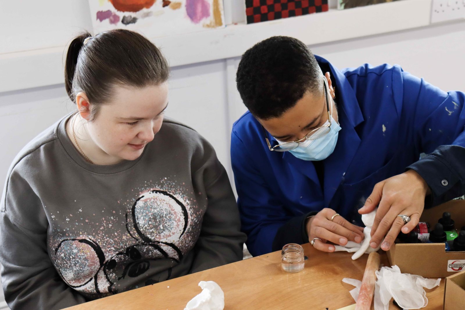 Rudy and a workshop participant working on a clay model together.