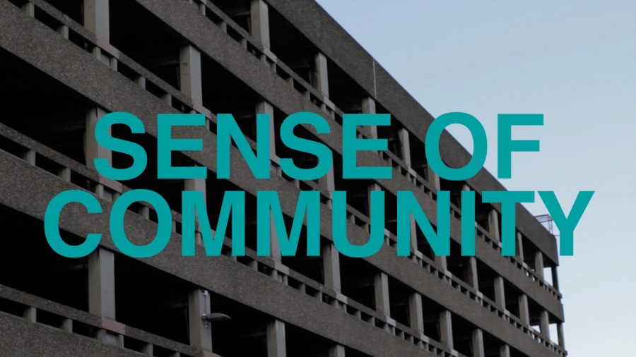 A photograph of a concrete car park with the words 'Sense of Community' in large, blue capital letters.