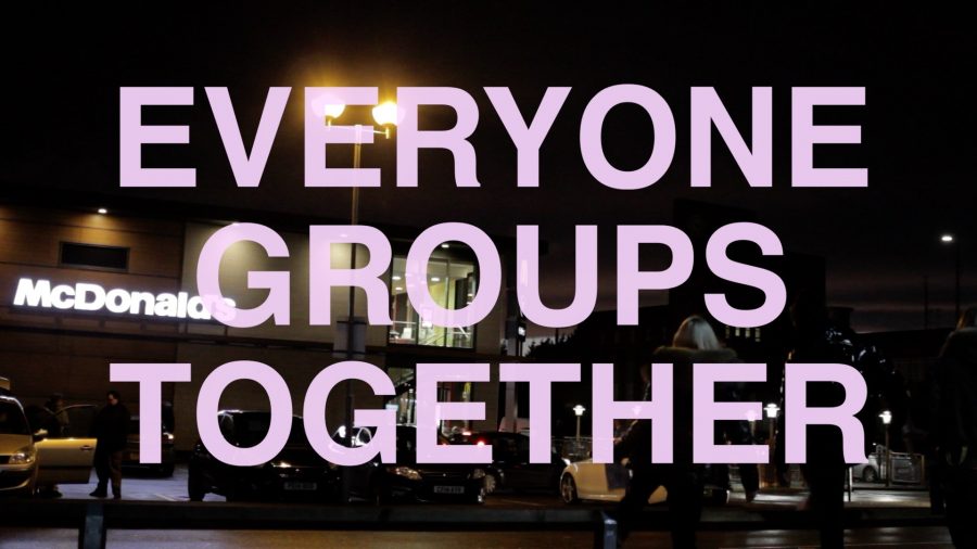 A photograph of a McDonalds with the words 'Everyone Groups Together' in large, lilac coloured capital letters.