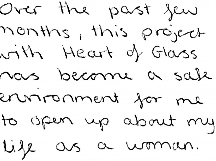 Black handwriting on a white background reading 'Over the past few months, this project with Heart of Glass has become a safe environment for me to open up about my life as a woman.'