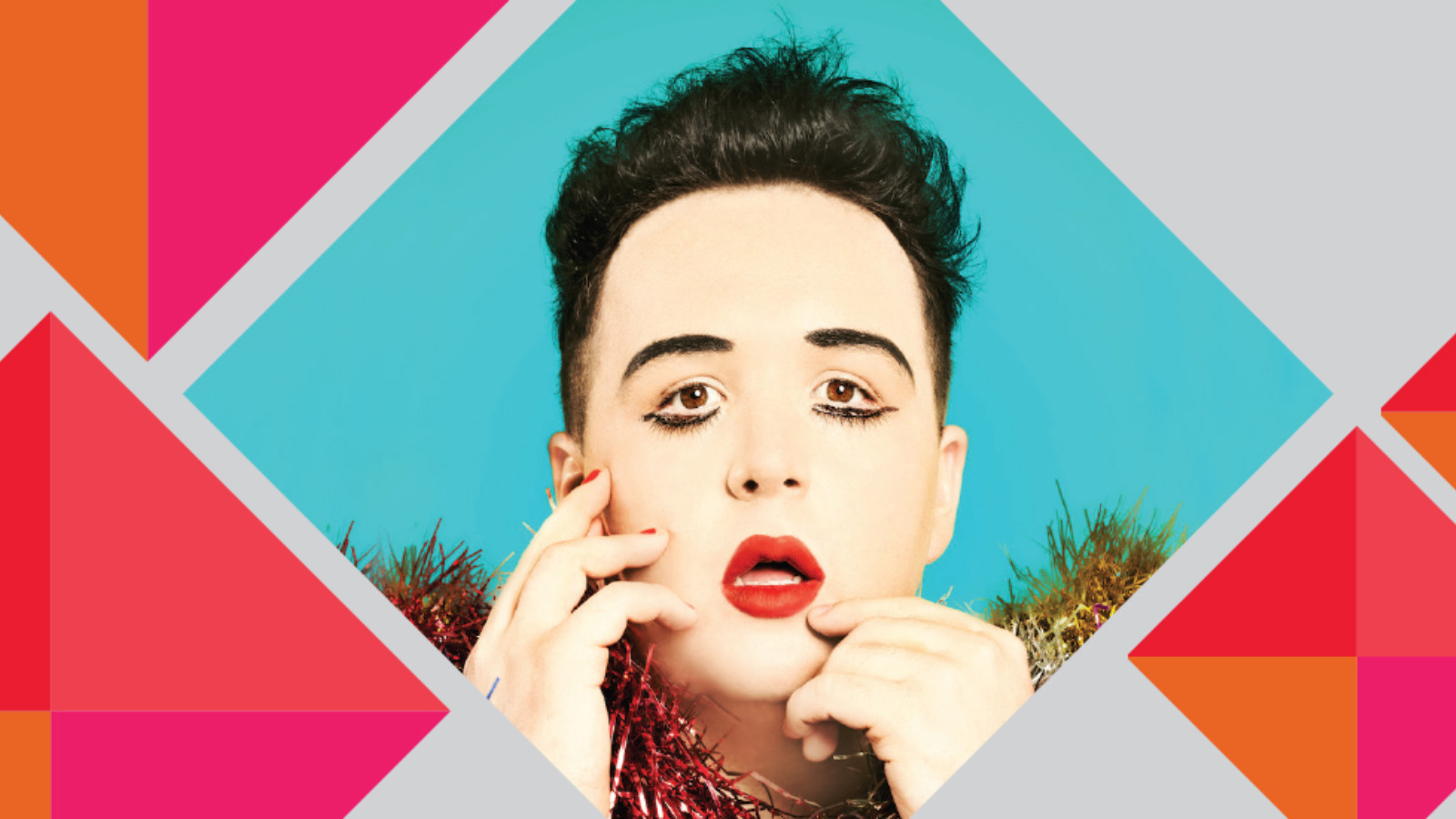 The artist Scottee wears bright red lipstick, false eyelashes and a glittering fluffy jacket against a blue background. This image is set against a graphic design of red, pink, orange and grey.