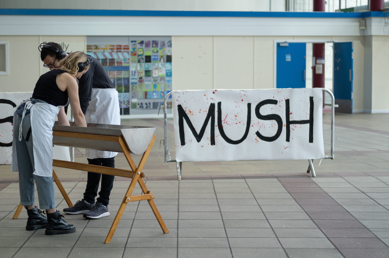 Participants with hands in dough in front of MUSH sign