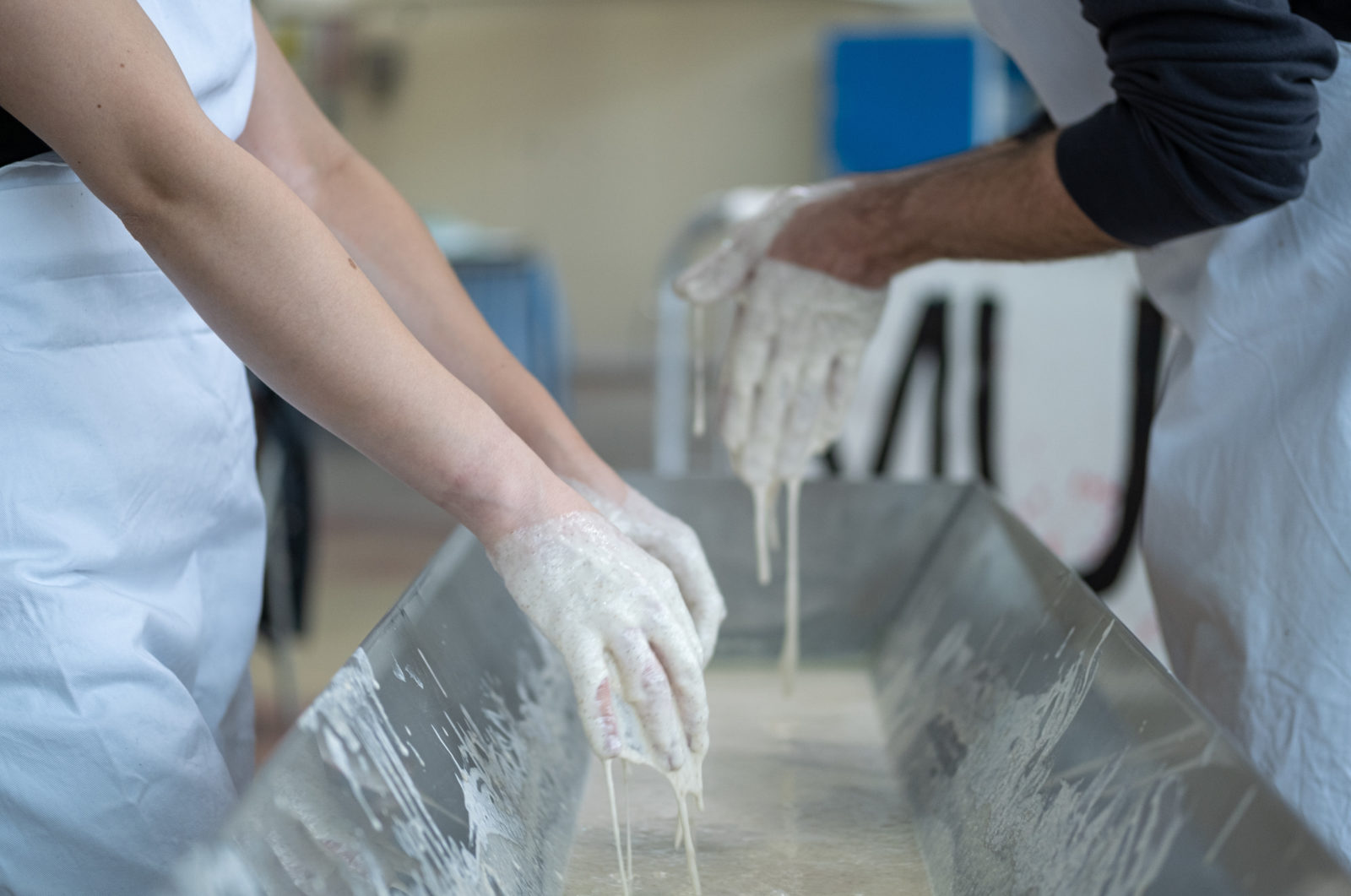 Hands mixing sourdough