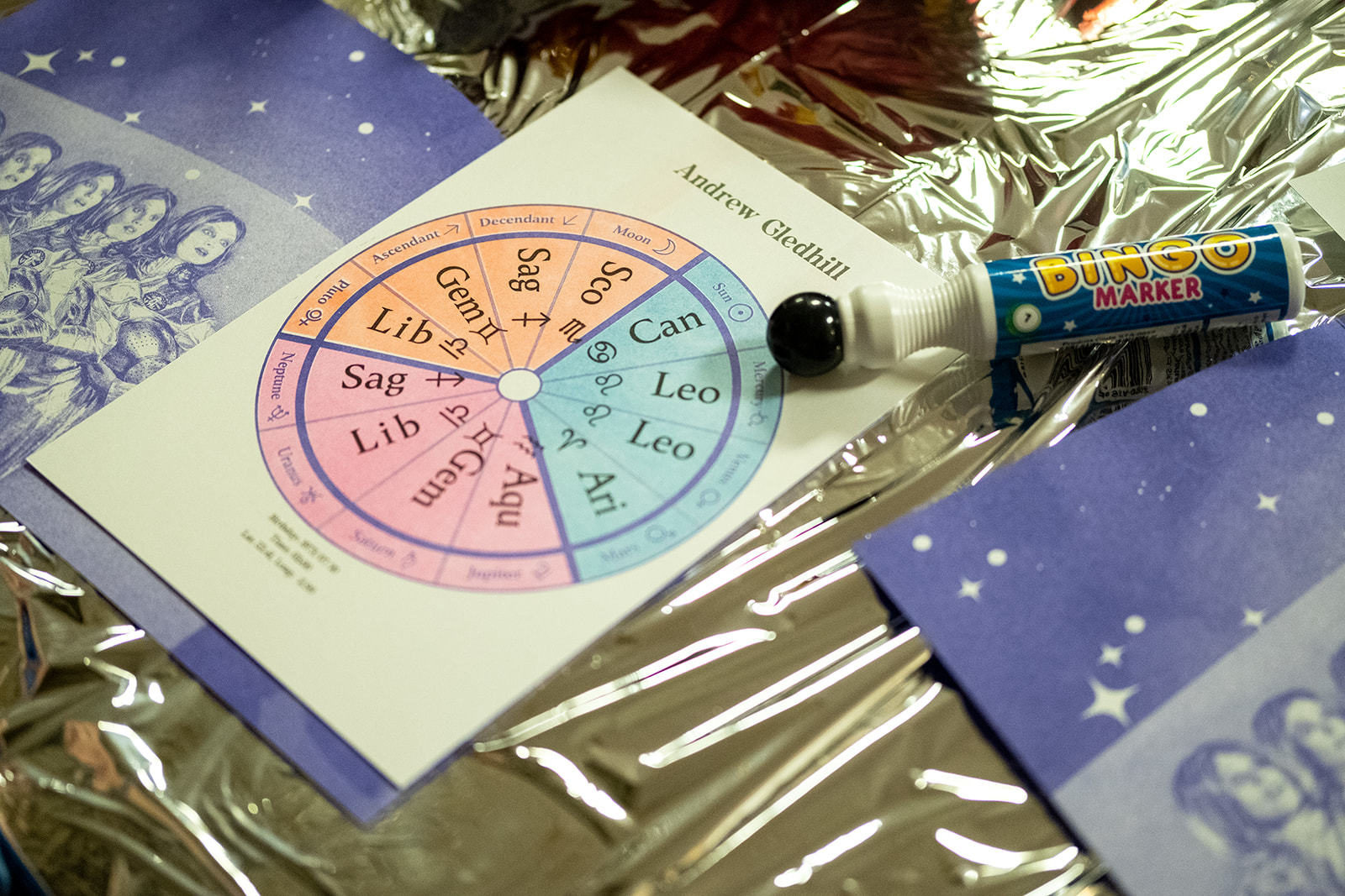 Personalised astrology bingo card on table with bingo marker