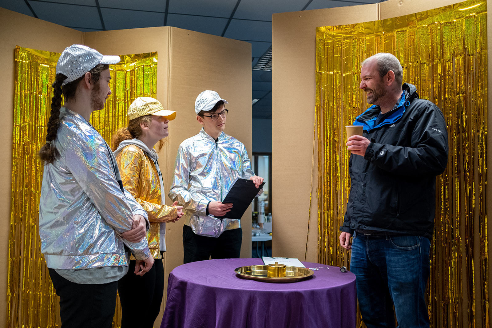 Team members chatting over a cup of tea with a local.