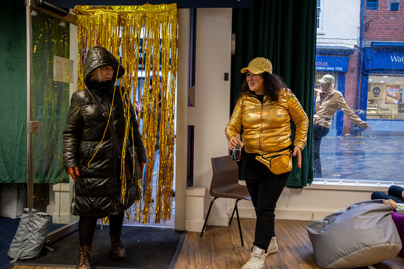 Woman entering the Cloakroom being greeted by Jenny