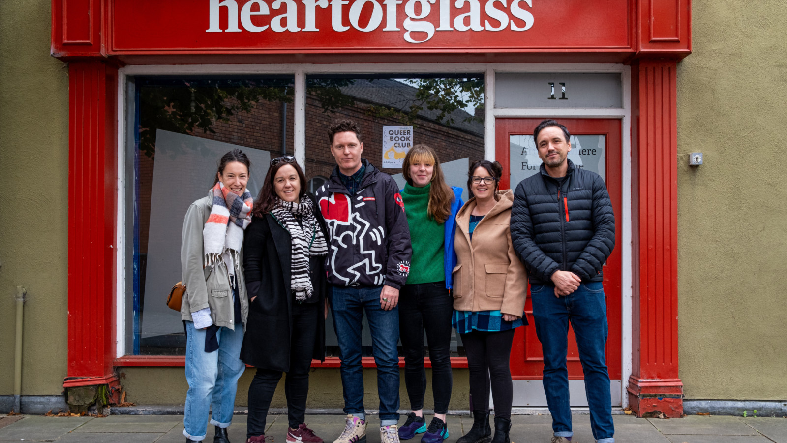Heart of Glass producers Kate and Suzanne smile in front of the Heart of Glass office with the What does he need team