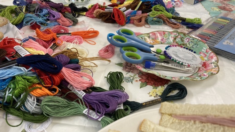 Photograph of sewing materials including threads, scissors and pins