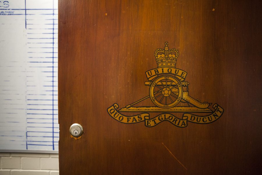 A crest painted in yellow gold on a wooden door.