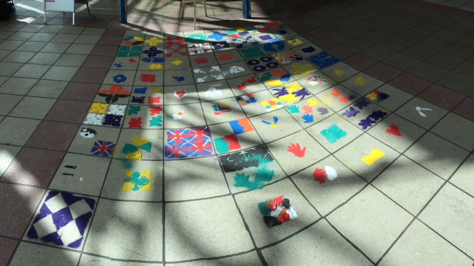 A colourful mosaic on floor tiles.